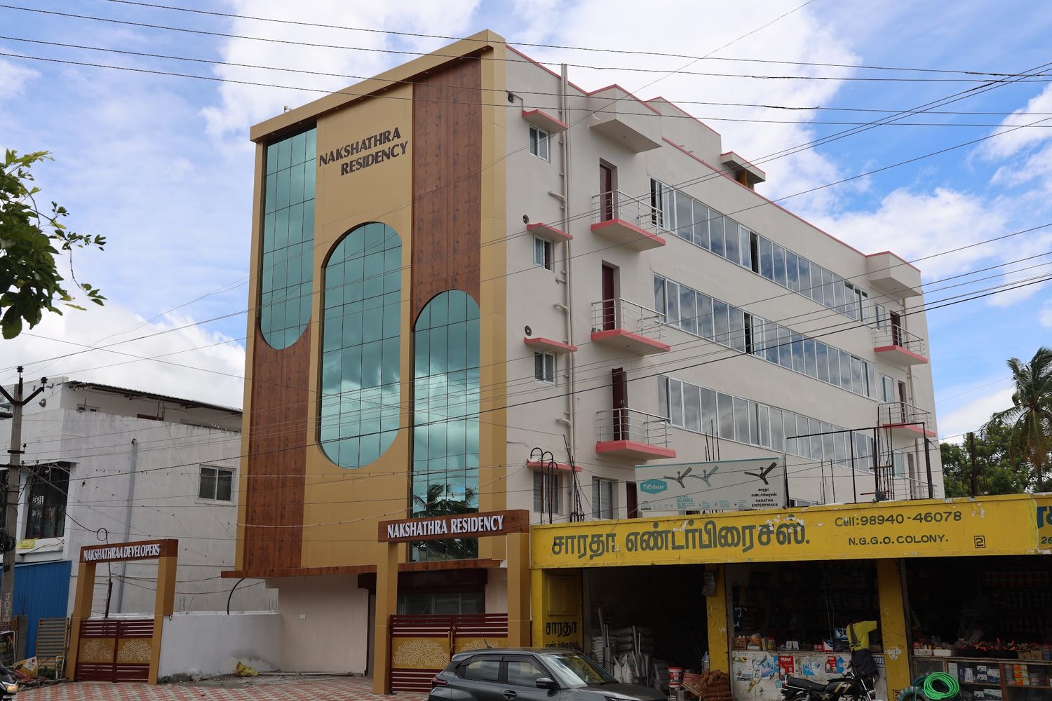 The front elevation of Nakshathra Residency showing the full height of the glazed tower and the balconies.